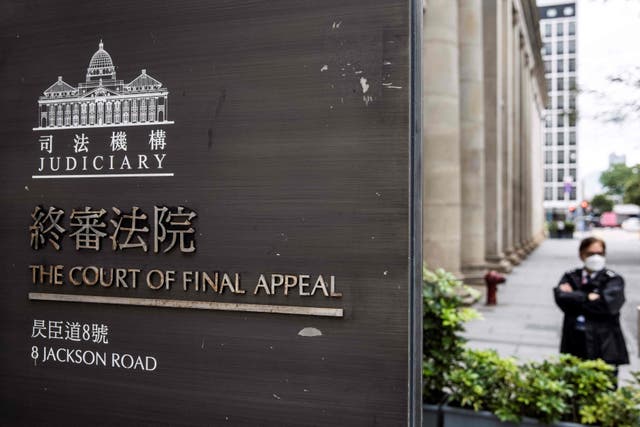 <p>File: A security guard (R) stands outside the Court of Final Appeal in Hong Kong on 31 March 2022</p>